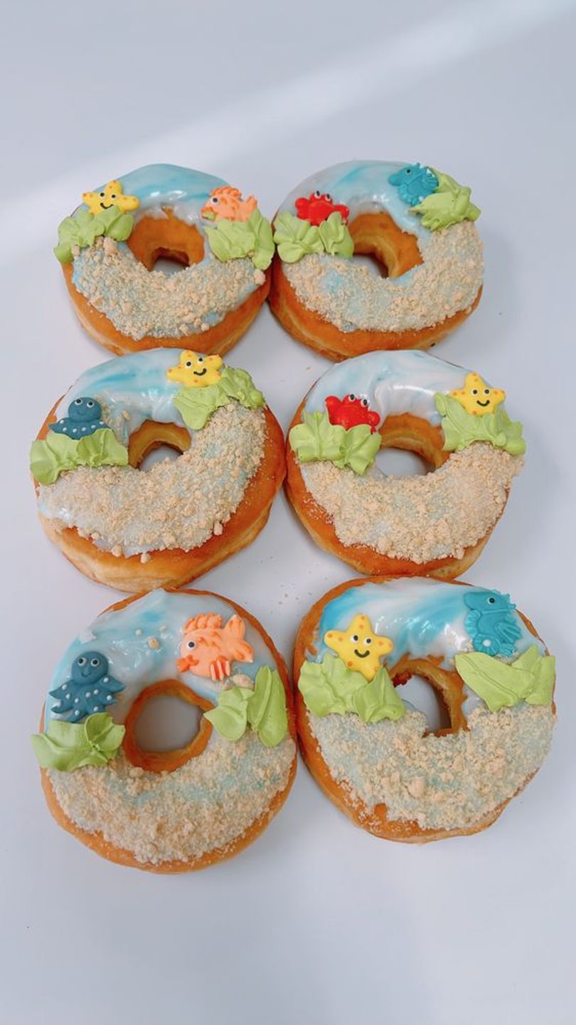 Under-the-sea beach-themed donuts with ocean icing and candy sea creatures.